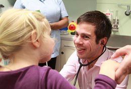 A doctor smiling at a child